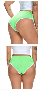 Detail der neongrünen Sportshorts mit weißem Kontrastrand und elastischem Stoff