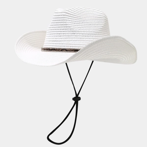 Close-up of white woven straw cowboy hat with snakeskin band and rhinestone detailing
