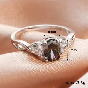 Gedraaide ring met kleurrijke ovale zirkoon en diamantaccenten op champagne zijde