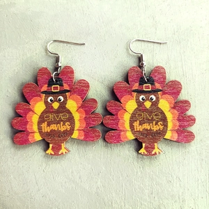 Detailed view of wood turkey earrings with Give Thanks lettering for Thanksgiving