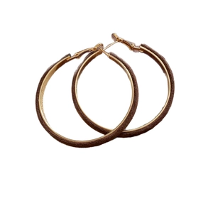 Retro brown flocked hoop earrings with gold-plated metal finish on a clean white background
