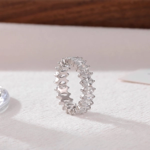 Eternity silver ring with oval cut cubic zirconia stones on soft background
