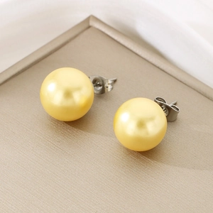 Detail of golden satin pearls with 12mm round luster on titanium steel stud earrings