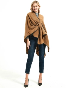 Detail of camel knit shawl featuring premium black leather trim and open-front buckle design