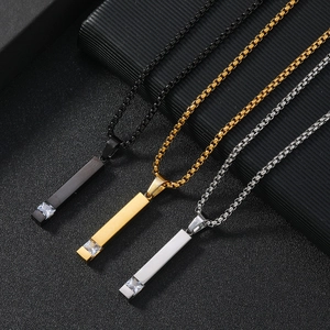 Detailed view of three stainless steel necklaces with zircon square pendants in black, gold, and silver