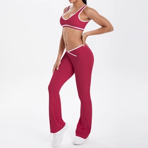 Detail of magenta yoga set with crossover V-waist flared pants and contrast trim