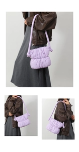 Detail view of a lavender puffed clouds bag with pleated nylon fabric and knotted shoulder strap