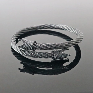 Detail of twisted cable cuff bracelet in gunmetal grey featuring ornate crown end caps