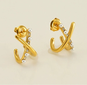 Detail of gold criss-cross earrings with gradient pearls and sparkling rhinestones