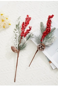 Close-up of Christmas berries and pine cones on a cream woven textured background