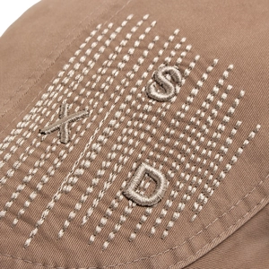 Detailed macro shot of a cotton beret hat featuring stylish 3D XSD letter embroidery