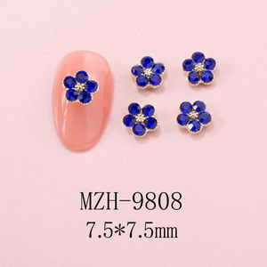 Macro view of 7.5mm blue five-petal flower nail charms with gold core for nail art decoration