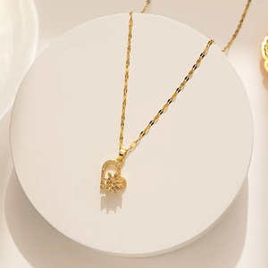Close-up of golden heart pendant with sparkling cubic zirconia on a delicate gold chain