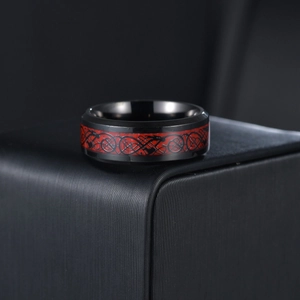 Detailed view of black dragon pattern on red background of the stainless steel ring