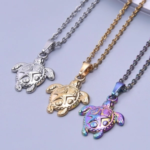 Detailed macro of stainless steel sea turtle pendants in gold, silver and rainbow colors