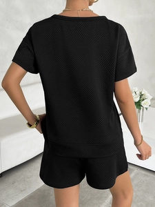 Detail of the diamond-textured knit fabric on the back of this black casual two-piece set