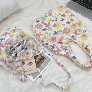 Detailed macro shot of floral organza tote bags with soft pastel flower patterns