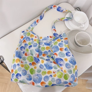 Top view of a minimalist cotton tote bag with colorful watercolor polka dot pattern prints