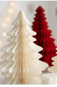 Macro detail of foldable honeycomb paper Christmas trees in cream and deep red colors