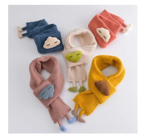 Detail of soft knitted baby scarves with plush cloud embroidery and knit foot accents