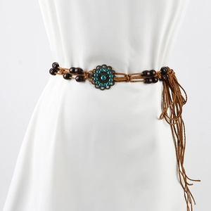 Close-up of brown woven belt with wood beads, turquoise floral buckle and side tassels