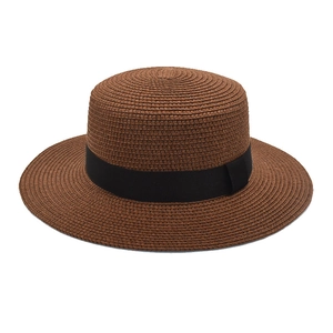 Detailed weave of dark brown boater straw hat with elegant black grosgrain ribbon band