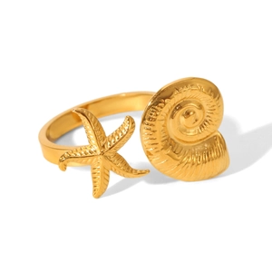 Detailed view of the gold-tone starfish and conch seashell elements on the open metal ring