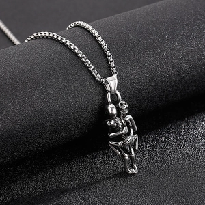 Vintage stainless steel necklace featuring two hugging skulls with a polished silver finish