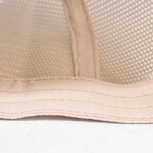 Close-up of trucker hat interior with beige mesh fabric and durable stitched seams