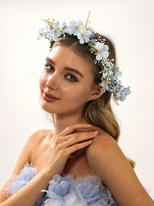Detail of light blue floral headband with artificial flowers on blonde model