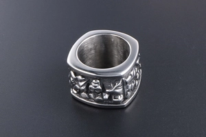 Macro view of wide silver titanium steel ring with intricate embossed patterns