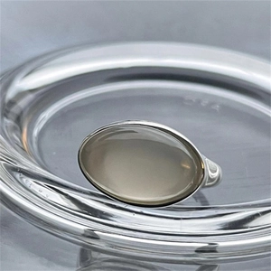Macro view of 925 sterling silver ring with oval gray gemstone in bezel setting