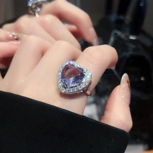 Detailed view of luxury silver ring featuring a heart-shaped purple zircon and diamonds