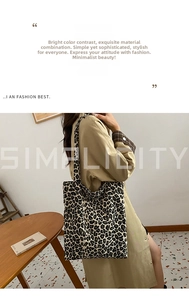 Close-up of leopard print canvas tote bag with wide shoulder strap in a modern home setting