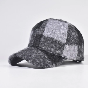 Detailed view of the textured plaid wool blend fabric on a structured baseball cap