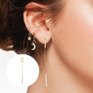 Close-up of golden long chain tassel earrings with zircon stars and moon on model