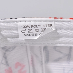 Close-up of 100% polyester washing label and care symbols inside the baseball cap
