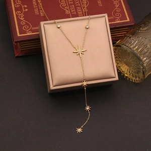 Elegant gold Y-shaped necklace with octagram pendants and zircons on vintage background