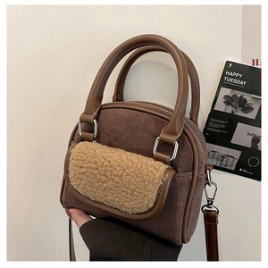 Detail of plush faux fur texture and brown suede fabric on the crossbody handbag