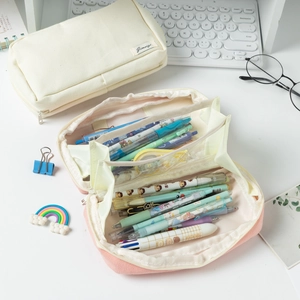 Close-up of the double-layer interior of a large-capacity canvas pencil case with mesh pocket