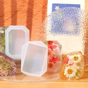 Macro shot of geometric silicone resin mold and dried flower crystal resin specimens