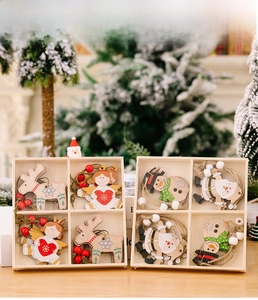 Detailed view of wooden Christmas tree ornaments featuring reindeer and angels in a box