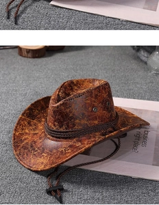 Macro detail of brown distressed faux leather cowboy hat with braided cord and chin strap