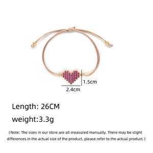 Adjustable gold braided bracelet with purple pixel heart charm and freshwater pearls