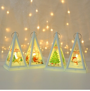 Close-up of white pyramid Christmas lanterns with warm LED candle light and holiday patterns