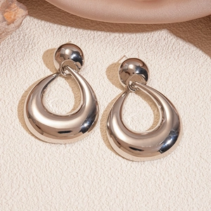 Macro shot of silver chunky teardrop earrings with high-polish metallic finish