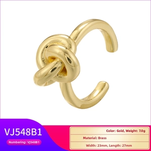 Macro shot of 23mm gold-plated brass knot ring showing dimensions and 7.0g weight