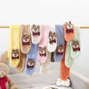 Detail of plush faux rabbit fur kids scarf with cute cartoon deer and bow decoration