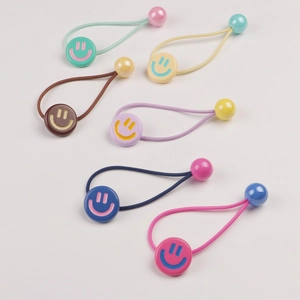 Close-up of 6 colorful elastic hair ties with smiley face charms and matching beads