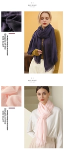Detail of solid color cotton linen scarf with frayed fringe edges in purple and pink